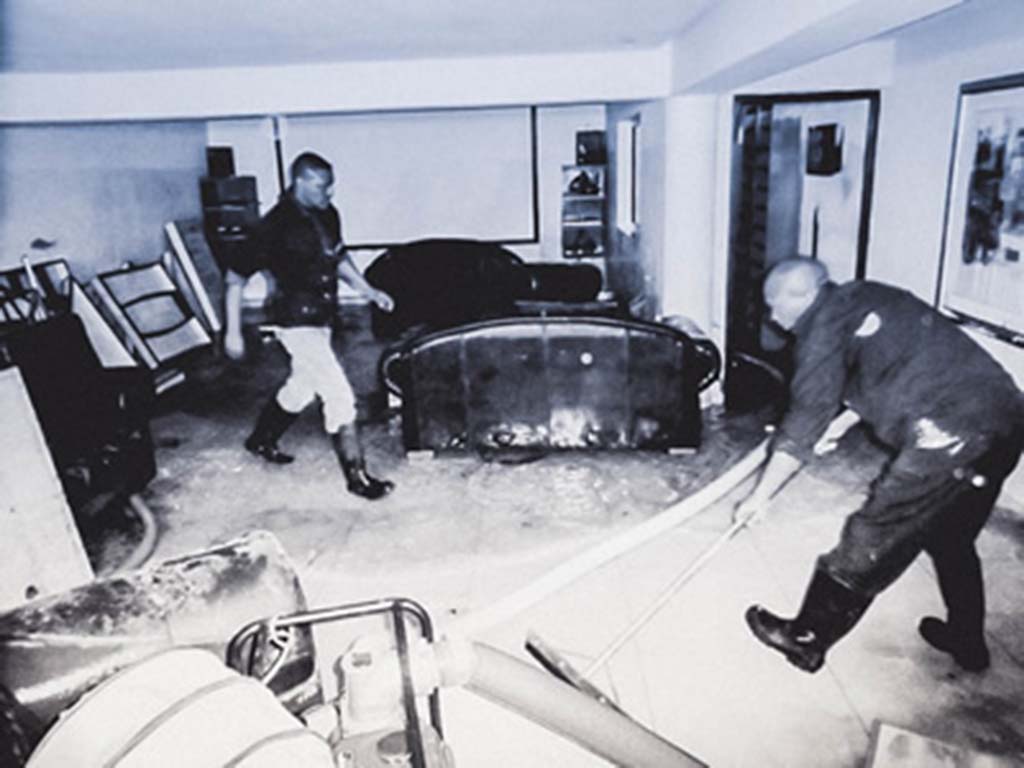 Image of an SRT crew removing water from a flooded room, showcasing expertise in water damage restoration.