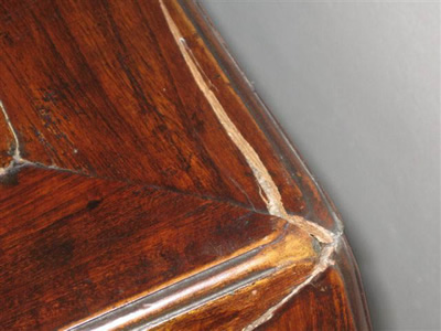 This close-up image offers a detailed look at the damage affecting a cabinet, highlighting the need for restoration.