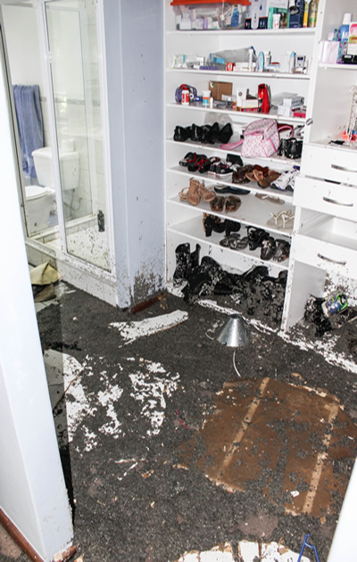 Image of a dressing room post-flood, showcasing the aftermath and need for restoration.