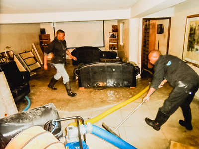 Image capturing System Restoration Technologies Team extracting water from a room post-flood, showcasing effective restoration.
