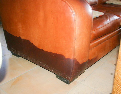 Image depicting a damaged leather armchair after a flood, highlighting the need for immediate restoration.