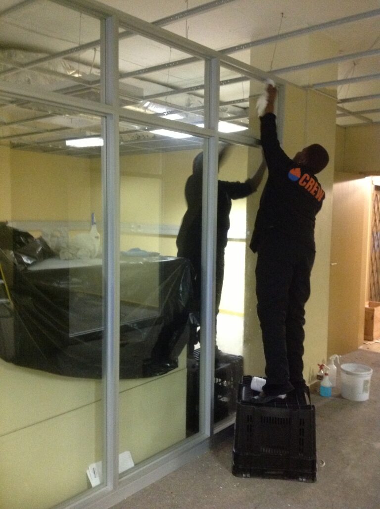 System Restoration Technologies employees diligently cleaning and working on office restoration.