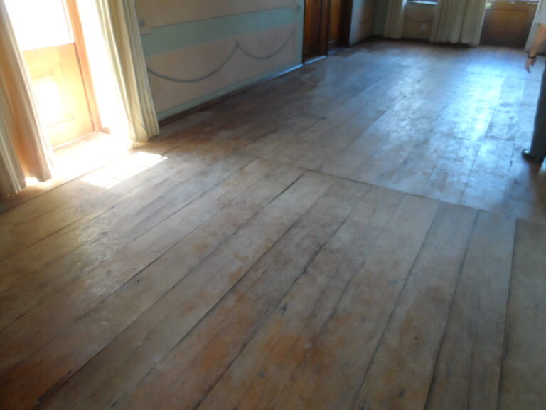 Faded and damaged wooden floor in need of restoration
