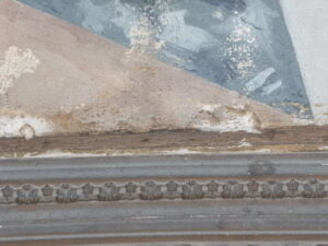 Image of a damaged painting and frame, showcasing the need for restoration services.